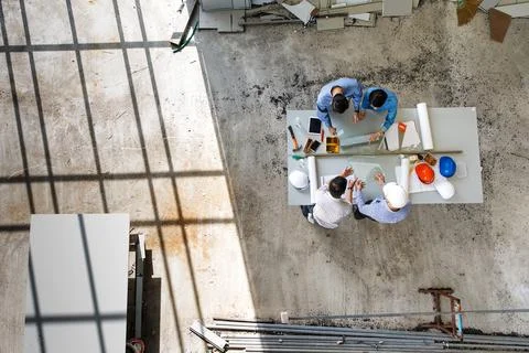 Four engineers in team making a discussion at construction site with several Stock Photos