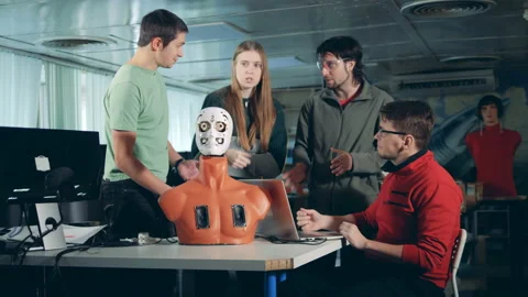 Four engineers working together with a humanoid, cyborg, robot. 스톡 동영상 101101936