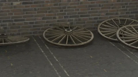 The four fallen wheels of an old cart crash into a brick wall. Outdated Stock Footage 148289270