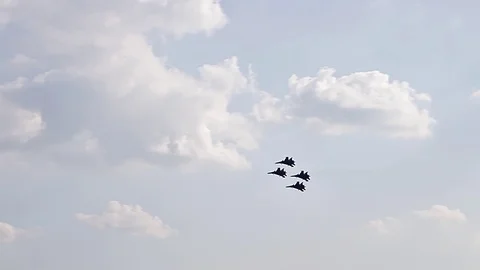 Four fighter jets in the blue sky. A general plan. Aerobatic figures. Airshow Stock Footage 124143063