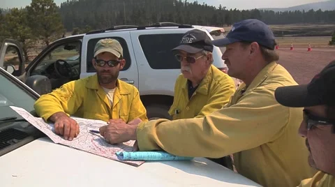 Four fire bosses planning strike on fire with map Stock Footage 40750605