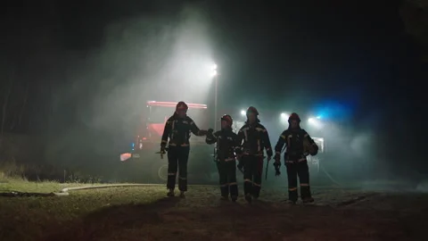 Four Firefighters doing their job at night Stock Footage 283139498