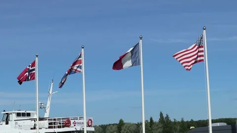 Four flags against blue sky Stock Footage 133993385