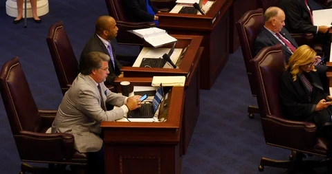 Four Florida state senators at desks during floor debate 2019 session Stock Footage 107499755