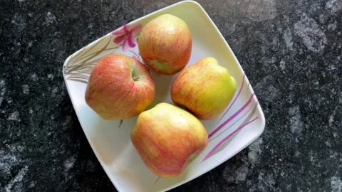 Four Fresh Red Apples Arranged on a Plate 動画素材 320786539