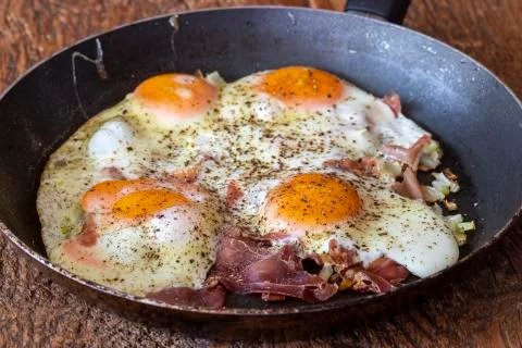 Four fried eggs in a pan Stock Photos