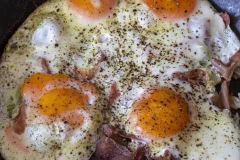 Four fried eggs in a pan Stock Photos
