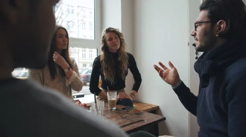 Four Friends Conversing in Bright Café Stock Footage 59785232