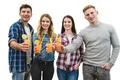 The four friends with cups sit on the sofa on a white wall background Photo