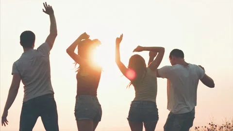 The four friends dancing on the sunrise background. slow motion Stock Footage 134833385