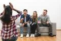 The four friends fun on the white wall background Photo