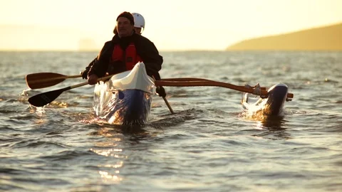 Four friends have fun kayaking on the ocean. Stockbeeldmateriaal 88405719