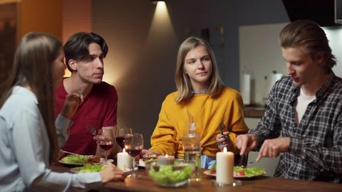 Four friends having delicious dinner Stock Footage 114812337