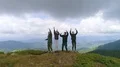 The four friends jumping on the mountain with a beautiful landscape 4k or 4k+ Resolution