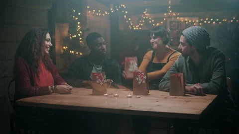 Four of Friends opening presents at a pub with happy expressions Stock Footage 132014353
