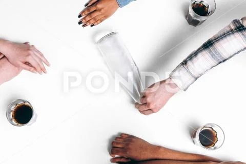 Four friends play spin the bottle game, flat lay Stock Photos