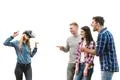 The four friends play with virtual reality glasses on a white background Photo