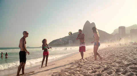 Four friends playing volleyball on Ipanema beach Stock Footage 59377294