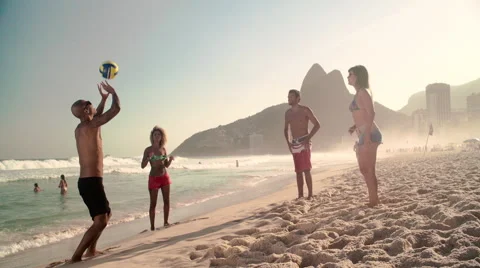 Four friends playing volleyball on Ipanema beach Stock Footage 59377341