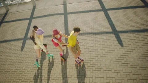 Four Friends rollerskating on the broadwalk Stock Footage 279343054