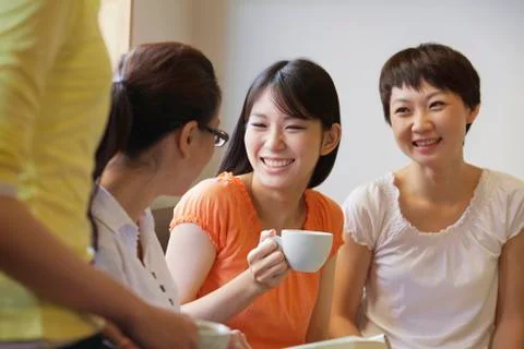 Four Friends sitting and talking in a coffee shop, Beijing Stock Photos