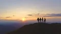The four friends standing on the mountain against the beautiful sunrise 4k or 4k+ Resolution