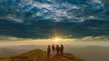 The four friends standing on the mountain against a beautiful sunset 4k or 4k+ Resolution