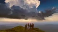 The four friends standing on the mountain against a beautiful sunset 4k or 4k+ Resolution
