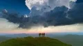 The four friends standing on the mountain against the picturesque sunset 4k or 4k+ Resolution
