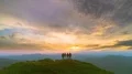 The four friends standing on a mountain against the picturesque sunrise 4k or 4k+ Resolution