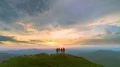 The four friends standing on a mountain against a picturesque sunrise 4k or 4k+ Resolution