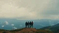 The four friends standing on a top of mountain 4k or 4k+ Resolution