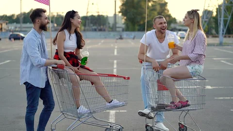 Four friends talking and smiling at the parking. Video stock 109614675