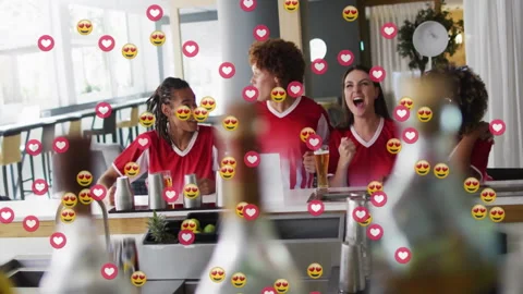 Four friends wearing red jerseys cheering at hospitality bar counter, with Stock Footage 307944844