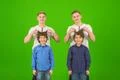 The four funny brothers stand on the green background Photo
