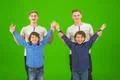 The four funny brothers stand on the green background Photo