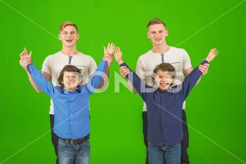 The four funny brothers stand on the green background Stock Photos