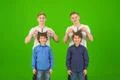 The four funny brothers stand on the green background Photo