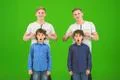 The four funny brothers stand on the green background Photo