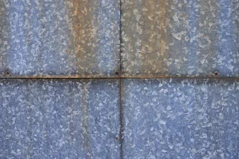Four galvanized old steel sheets with rust spots and aged rivets. Industria.. Stock Photos