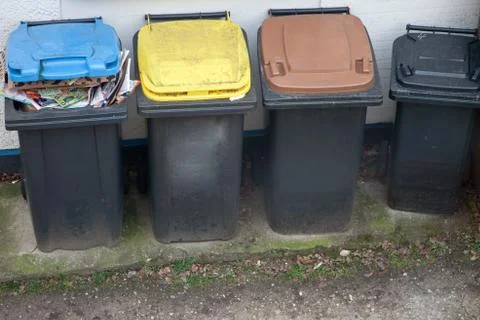 Four garbage bins colour coded for recycling Stock Photos