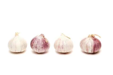 Four garlics in a row Stock Photos