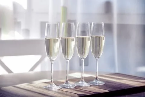 Four glasses of wine on a dining table Stock Photos