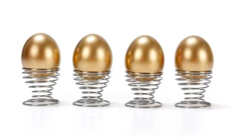 Four golden eggs in a row Stock Photos