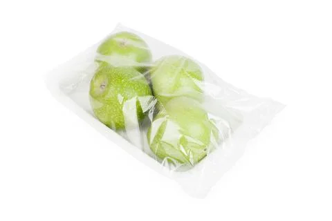 Four green apples in plastic container isolated white background Stock Photos