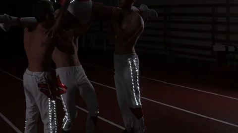Four gymnasts and acrobats perform sports power stance Stock Footage 129472809