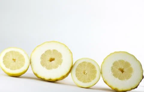 Four half lemons in section in line on white background Stock Photos
