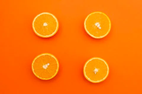 Four of half an orange on an orange background Stock Photos