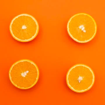 Four of half an orange on an orange background Stock Photos
