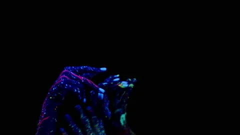 Four hand smeared with abstract paint and under an fluorescent lamp make Stock Footage 162971266